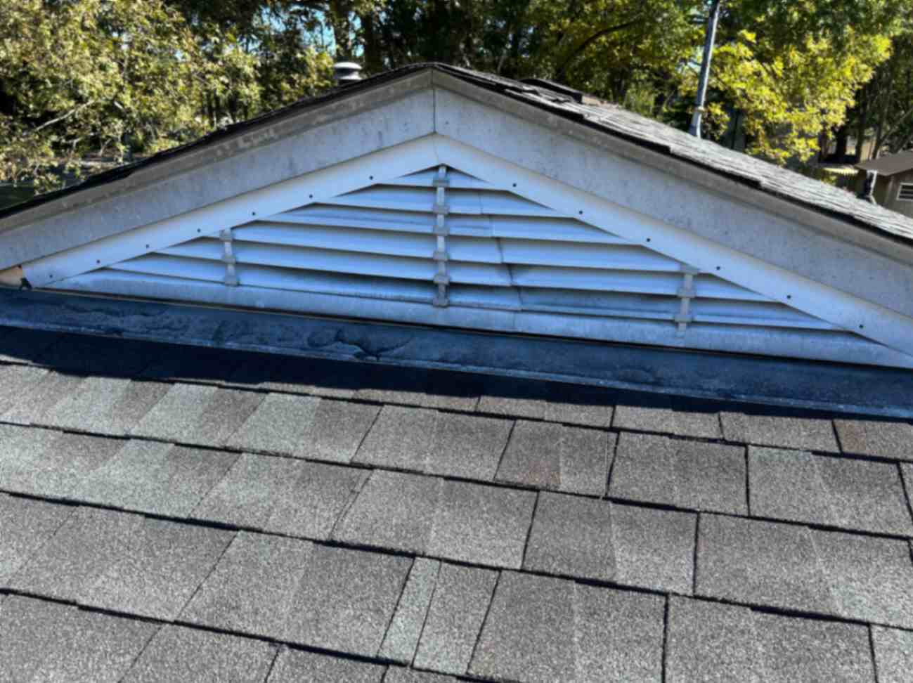 Gable roof vent with white slats beneath a shingled roof, taken during Squirrel Removal in High Point.